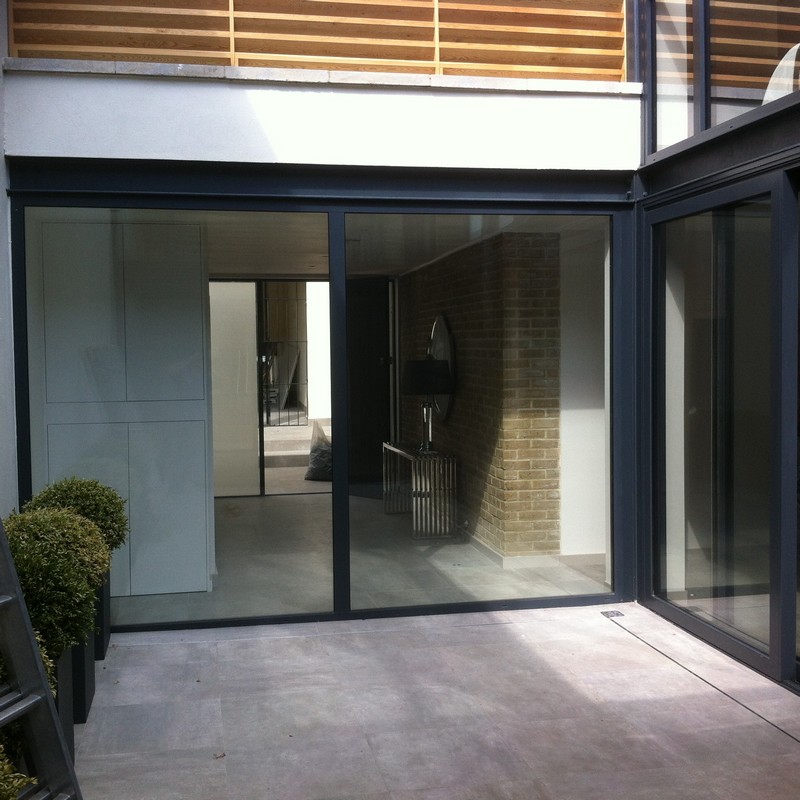 Floor-to-ceiling sliding doors opening to courtyard in St Albans
