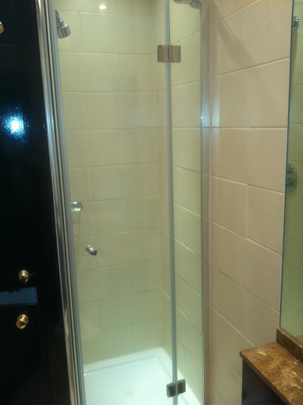 Frameless glass shower enclosure with chrome fittings in St Albans
